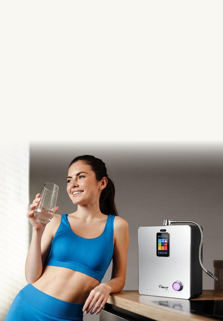 A fit young brunette woman wearing blue workout clothes drinking alkaline water Mobile view