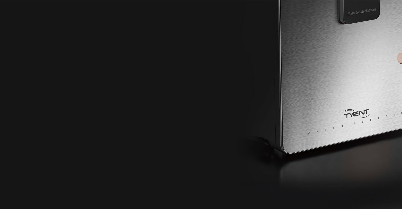 Close up of stainless steel Tyent Water Ionizer on a dark background