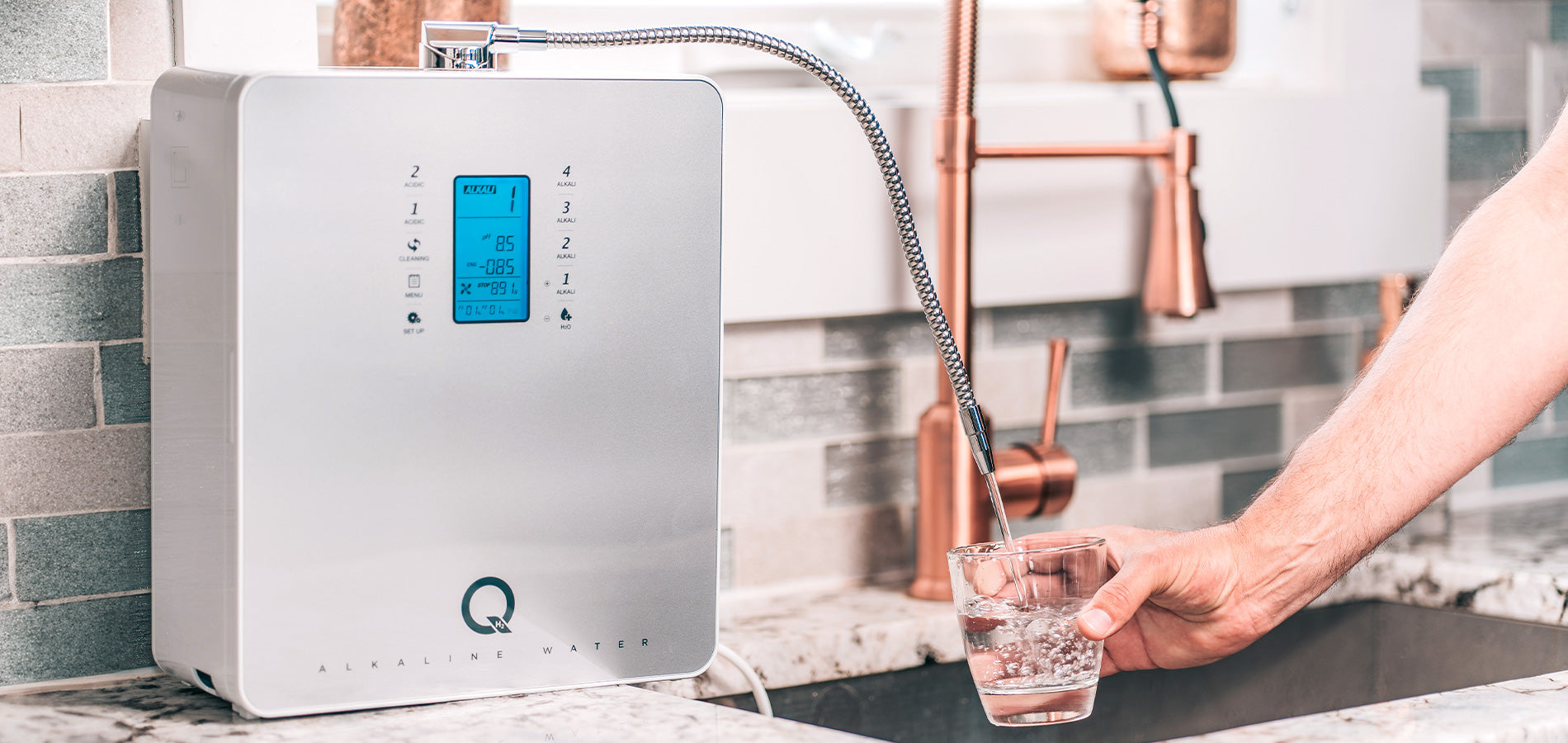 Filling up a glass of clean hydrating water from the Tyent Q Series alkaline water machine