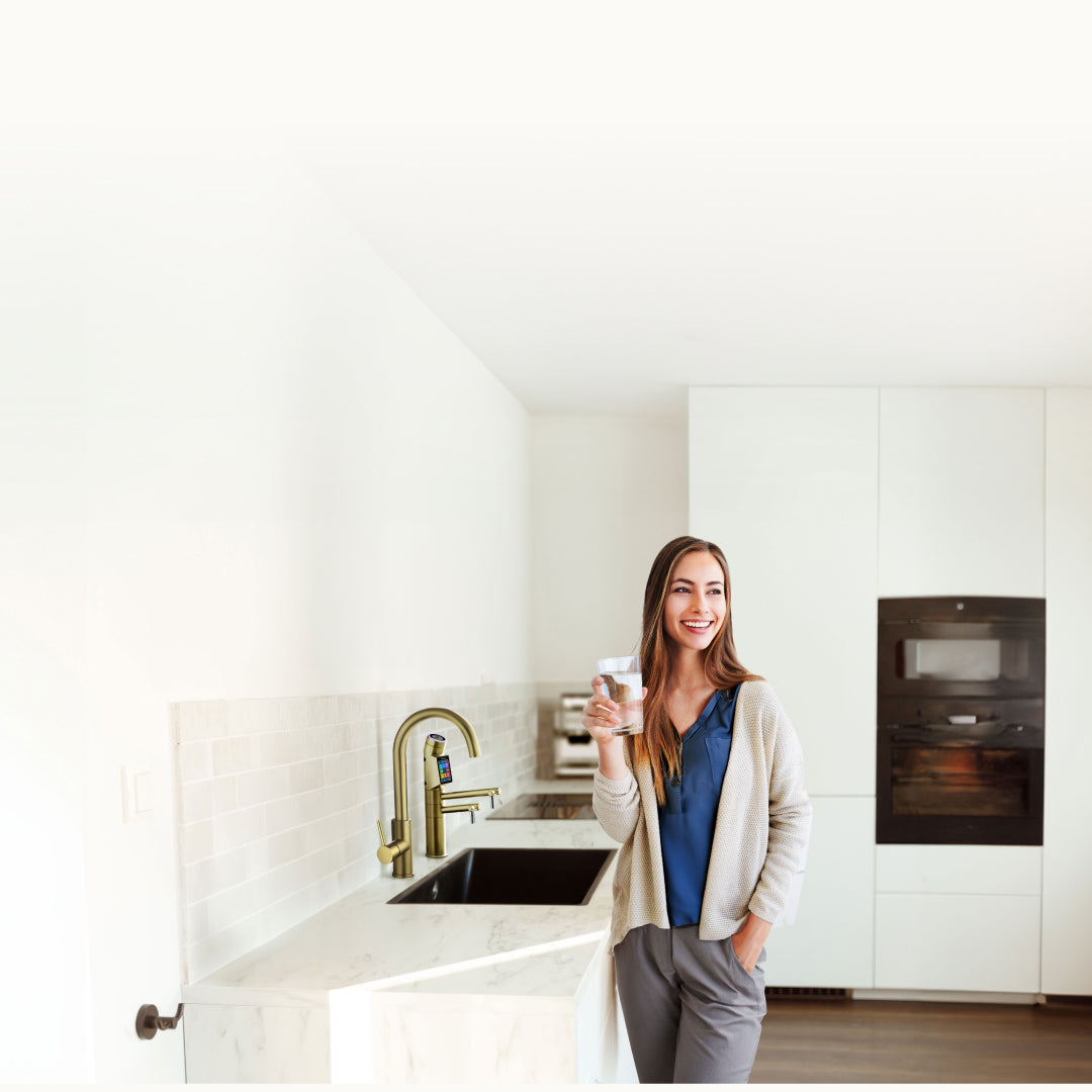 Young Woman Enjoying Tyent Water Ionizer in Modern Kitchen