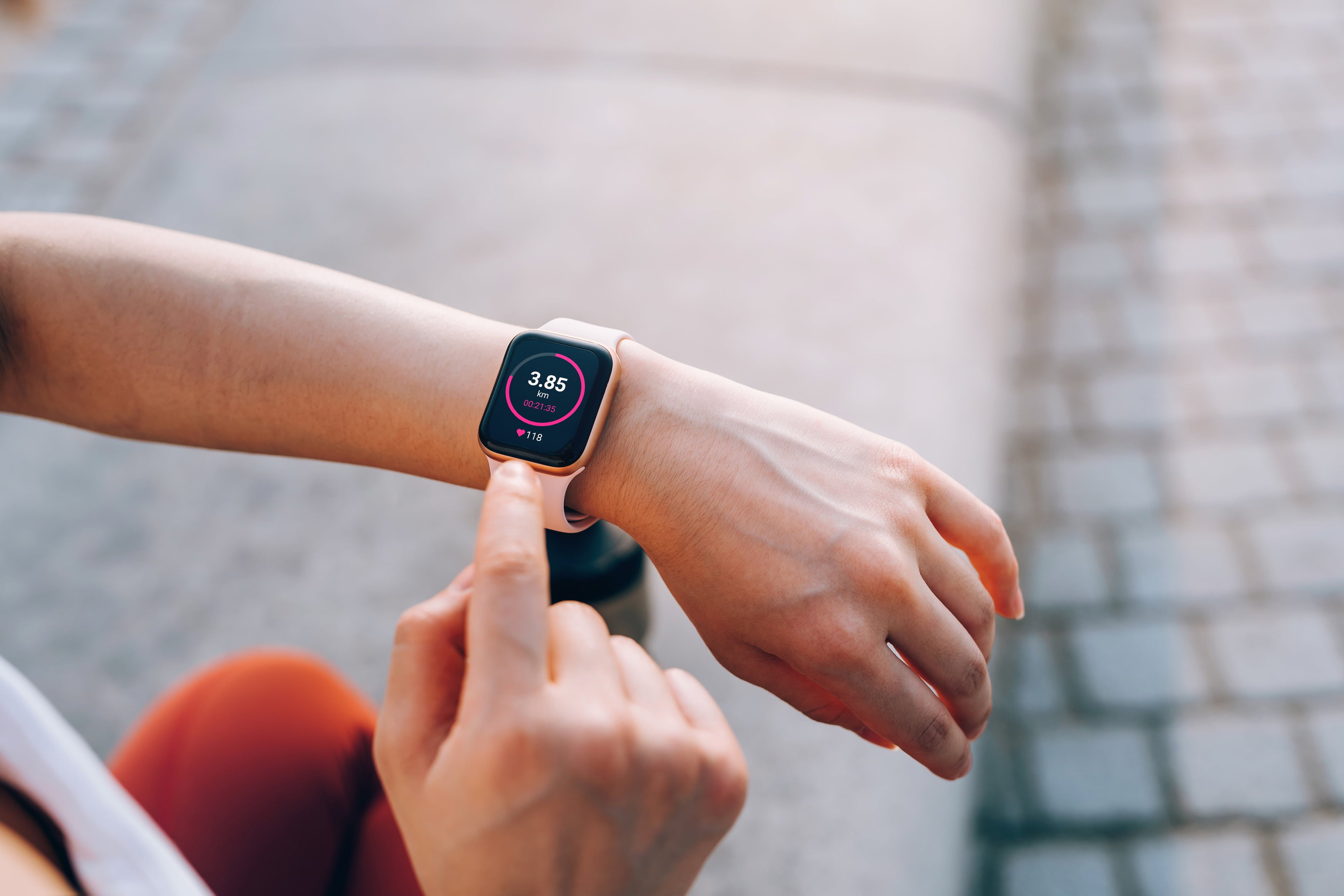 Person using a smartwatch with a blurred background