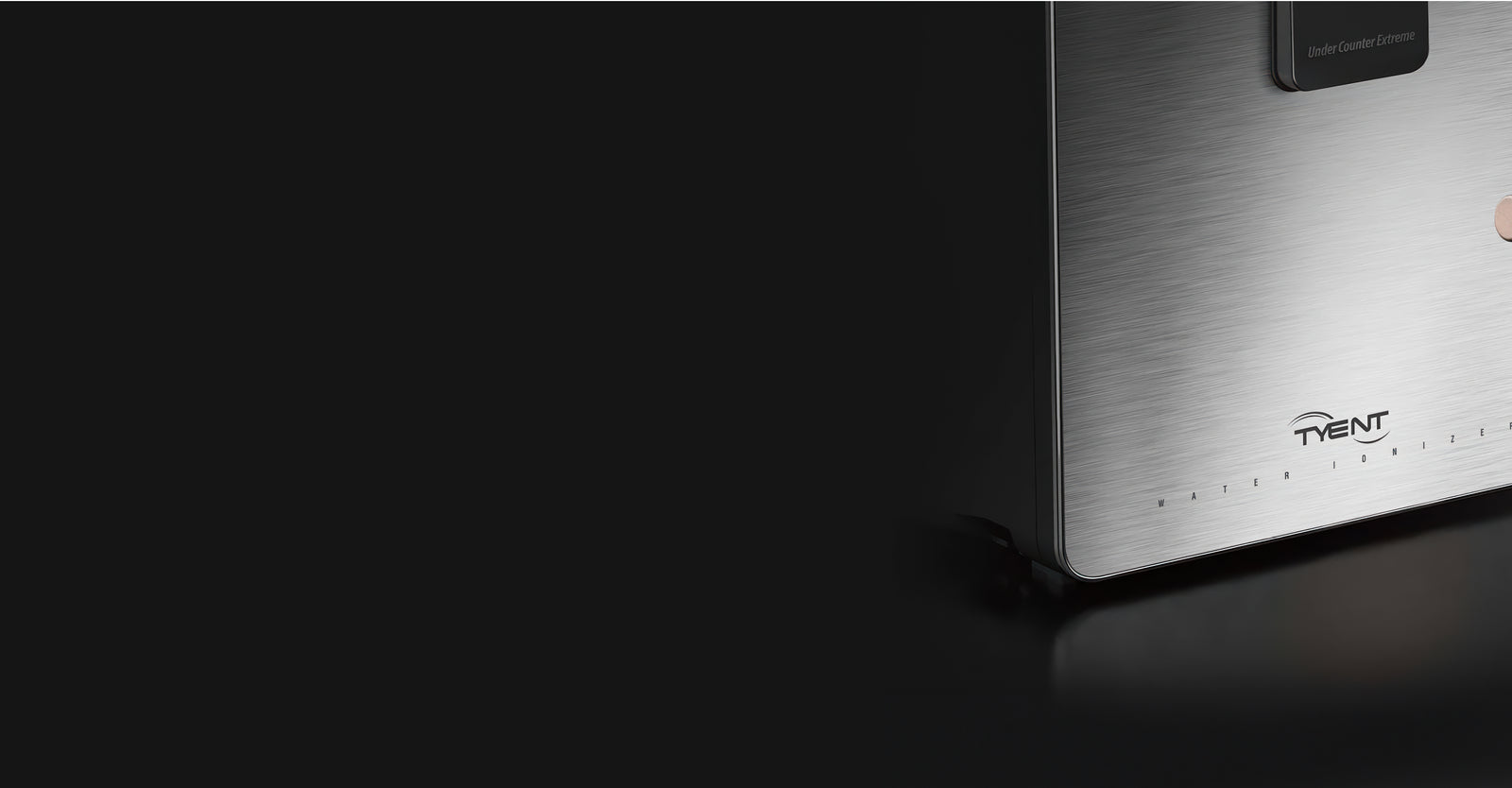 Close of stainless steel water ionizer with 'Tyent' branding on a dark background